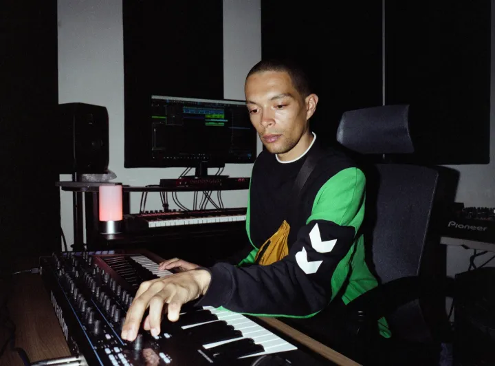 Batu in first year studio playing with synth 