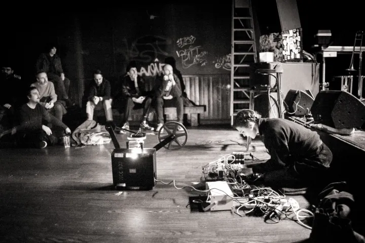 Guest sat down performing on stage with music hardware