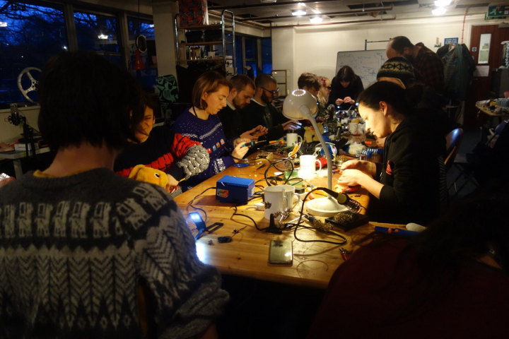 Group of people sat down at desk working on different projects 